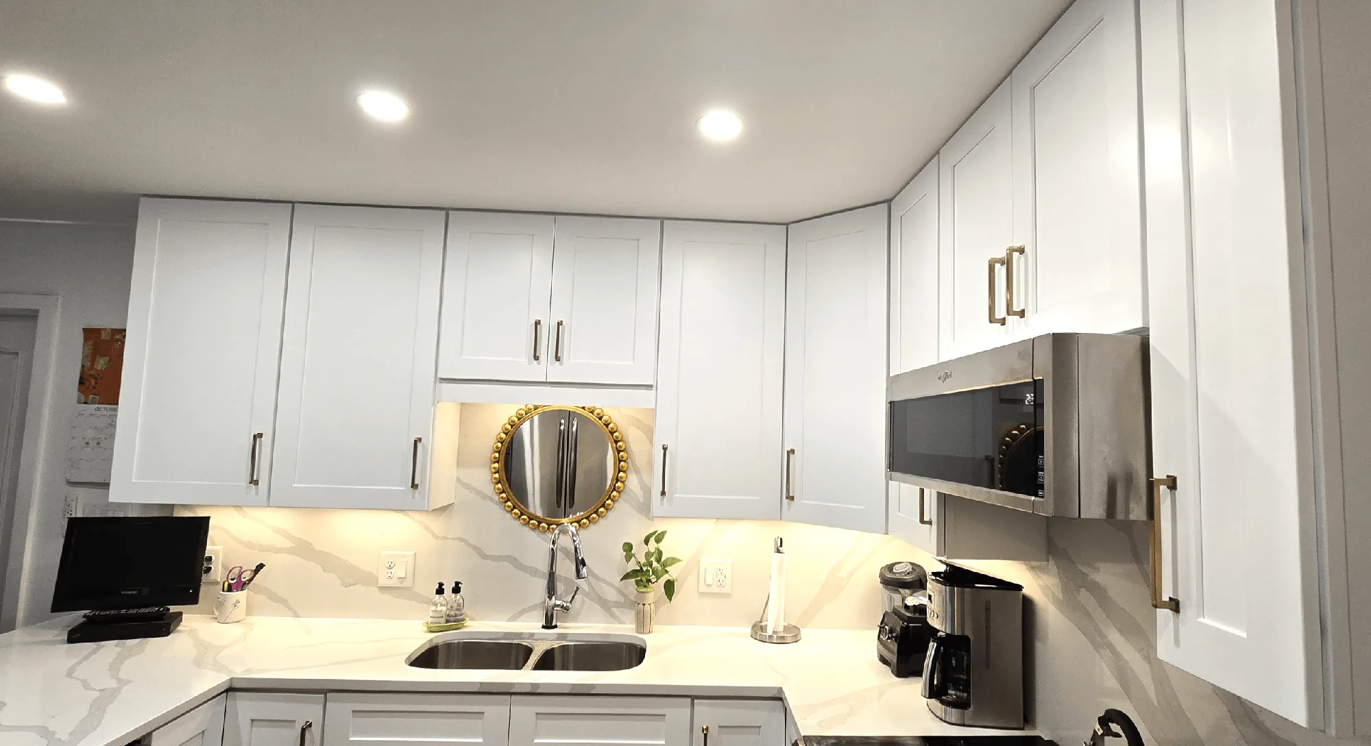 Completed white kitchen cabinetry and stone countertops